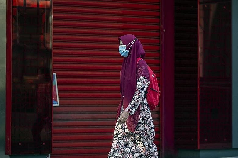 A woman wearing a mask in Kuala Lumpur on Tuesday. The government made the decision on wearing masks following the recent increase in Covid-19 cases and lack of compliance with standard operating procedures by the public.