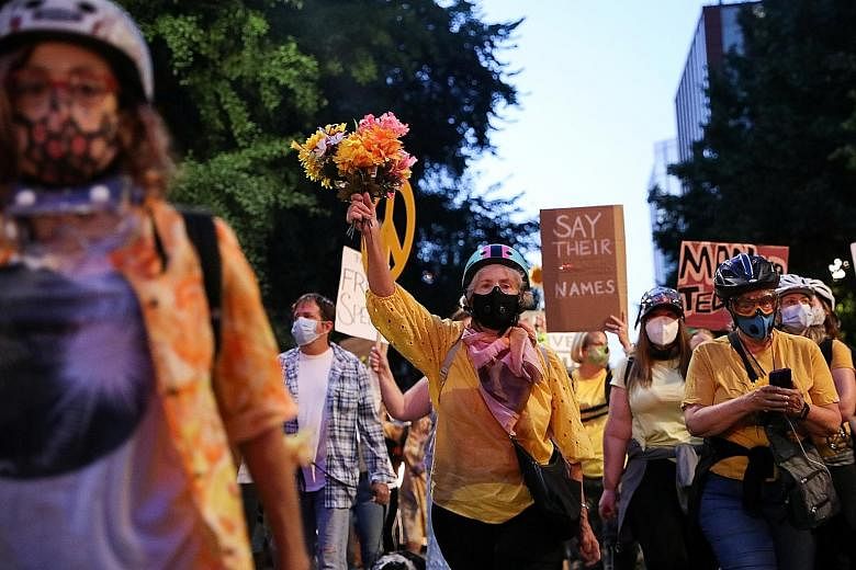 Carrying flowers and signs like "Feds stay clear. Moms are here", and "I'm so disappointed in you - mom", the women in Portland, Oregon, have been shoved and tear-gassed by federal agents but remain united in their determination to protect anti-racis