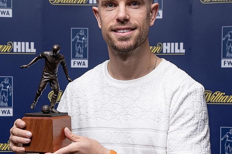 Liverpool captain Jordan Henderson with his Footballer of the Year trophy yesterday. 