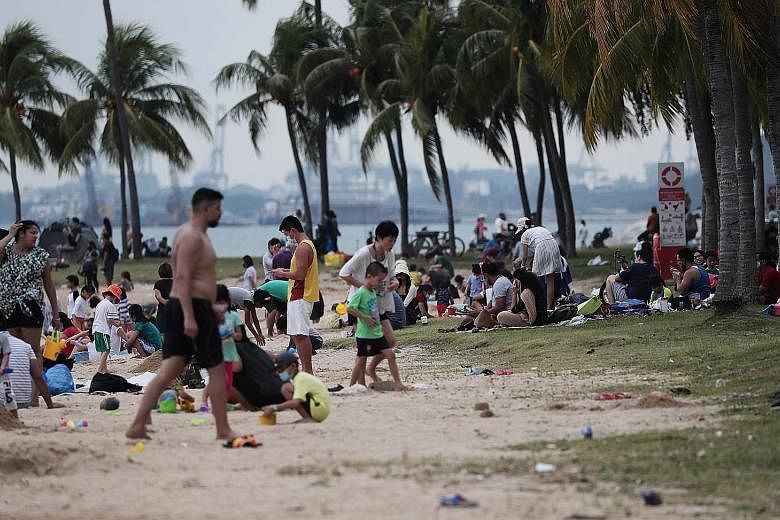 Right: Restaurants and bars in places such as Holland Village will continue to be closely monitored for breaches. Below: Beaches like the one at East Coast Park will see capacity limits implemented following crowding at the start of the school holida