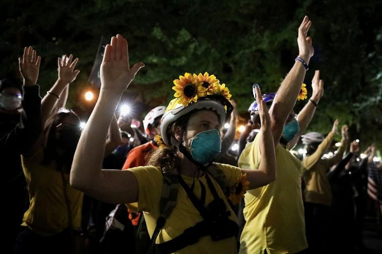 Mothers protesting against racial inequality and police violence in Portland, Oregon, on Thursday. PHOTO: REUTERS
