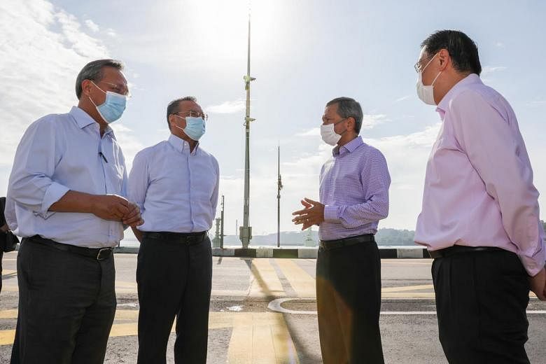 (From left) Johor Menteri Besar Hasni Mohammad, Malaysian Foreign Minister Hishammuddin Hussein, Singapore Foreign Minister Vivian Balakrishnan and Permanent Secretary for Foreign Affairs Chee Wee Kiong meeting at the midpoint of the Causeway yesterd