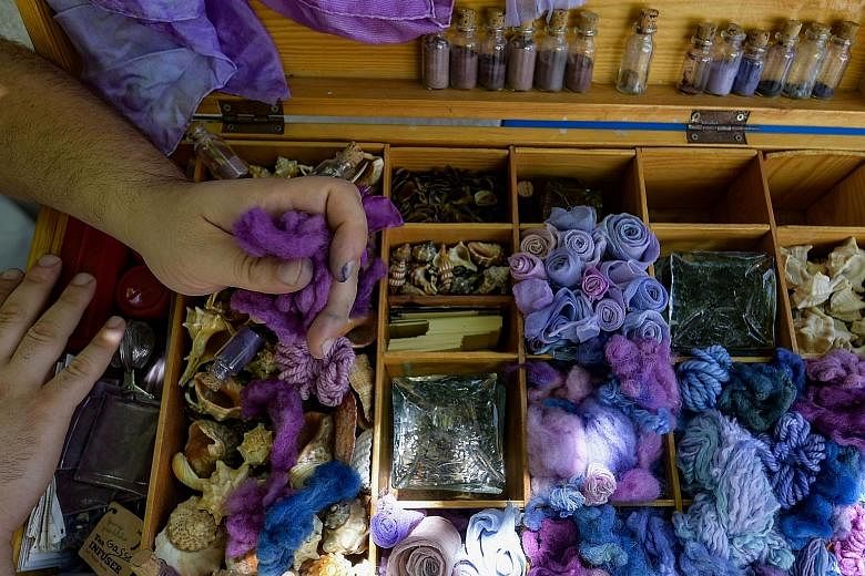 Craftsman Mohamed Ghassen Nouira keeps samples of purple yarn and fabric in a box at his workshop. A symbol of power and prestige, the colour purple was traditionally used for royal and imperial robes.