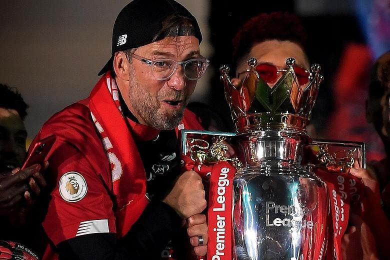 Jurgen Klopp, with the Premier League trophy, was named LMA's manager of the year. He joins a list of former Liverpool coaches to win the award.