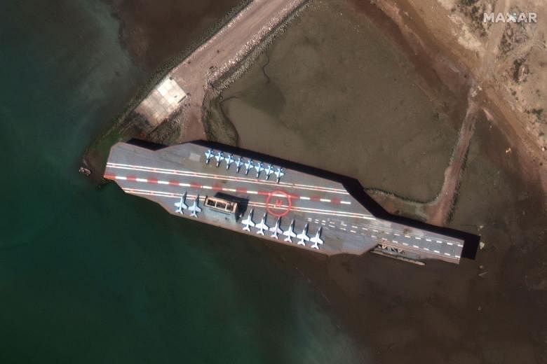 A handout image of a mock-up of the US aircraft carrier in Bandar Abbas, Iran. Military exercises were held near the Strait of Hormuz yesterday, where Iran's Revolutionary Guards blasted it with missiles.