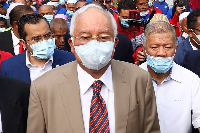 Former Malaysian prime minister Najib Razak arriving yesterday at the Kuala Lumpur High Court, where he was found guilty of seven charges, including abuse of power, and multiple counts of criminal breach of trust and money laundering for illegally re