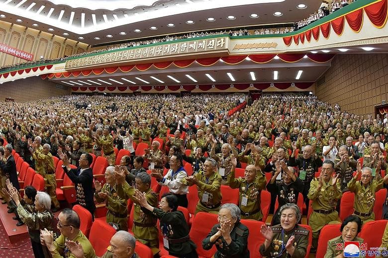Attendees cheering at the 6th National Conference of War Veterans at the April 25 House of Culture in Pyongyang on Monday. PHOTO: AGENCE FRANCE-PRESSE