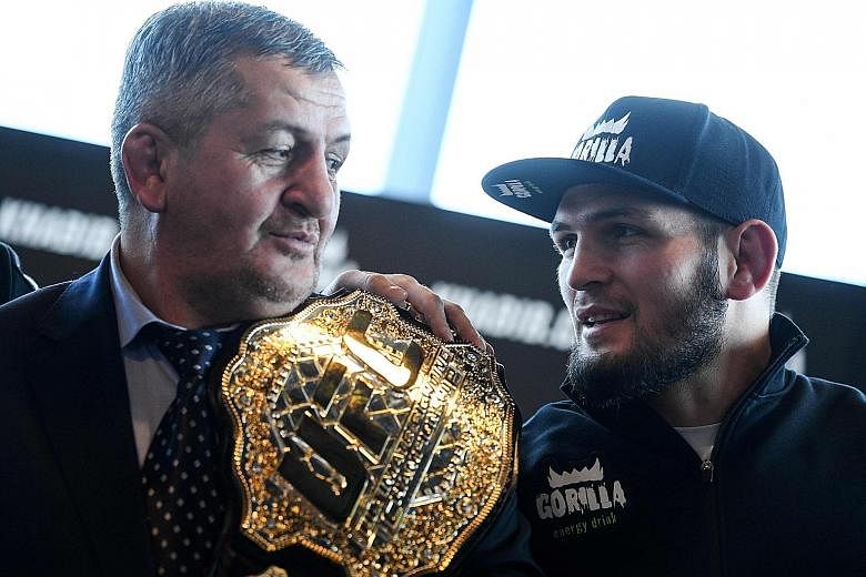 Khabib Nurmagomedov with his father in 2018. UFC chief Dana White says Abdulmanap's death this month from Covid-19 effects has "been very rough" on the Russian MMA fighter. PHOTO: AGENCE FRANCE-PRESSE