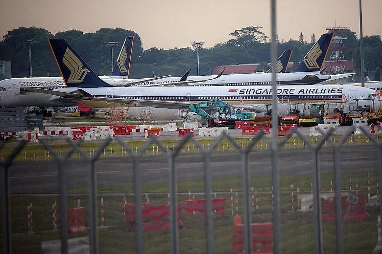 Singapore Airlines planes parked on the tarmac of Changi Airport last month as air travel demand evaporated amid travel restrictions and border controls imposed around the world to contain the spread of the coronavirus.
