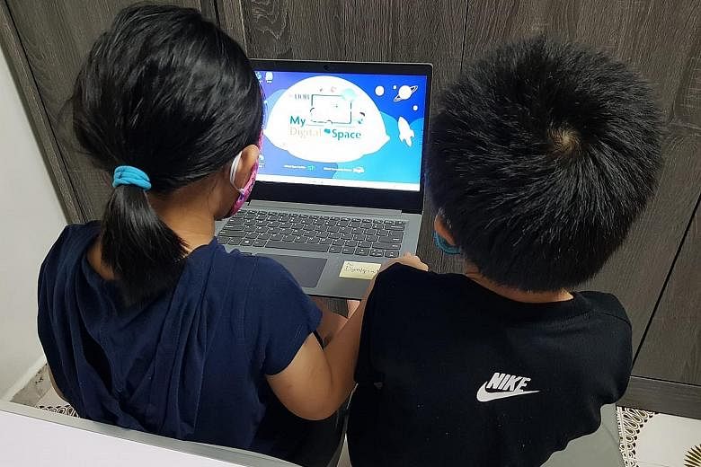 Rachel's children using one of two laptops on loan to the family under the UOB My Digital Space programme. Rachel (not her real name) was worried her children would fall behind when home-based learning kicked in as the family has only one laptop at h