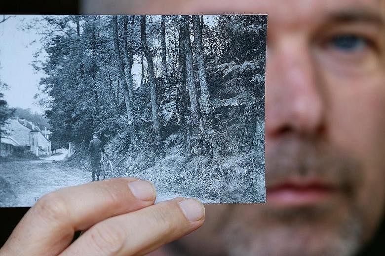 Researcher Wouter van der Veen, scientific director at the Van Gogh Institute, showing a copy of the postcard (left) which enabled him to identify the location of Vincent van Gogh's final painting, Tree Roots (below).