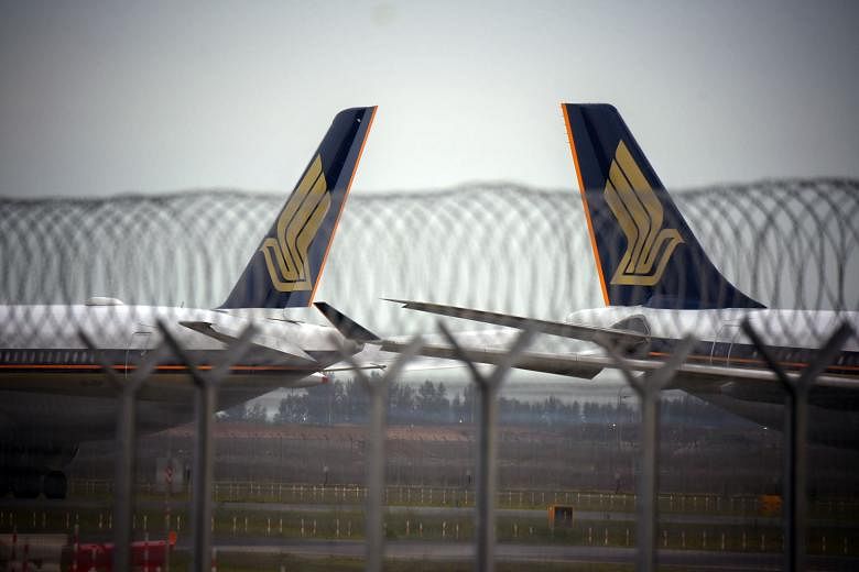 Singapore Airlines planes at Changi Airport last month. In his memo to staff, SIA chief executive Goh Choon Phong shared that industry experts now forecast it will take about two to four years for passenger traffic numbers to return to pre-pandemic l