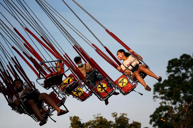 People at Dunia Fantasi amusement park in Jakarta on Sunday. Cities and provinces across Indonesia have gradually eased restrictive measures imposed as part of partial lockdowns. PHOTO: REUTERS