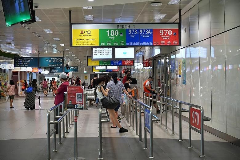 Commuters waiting for buses at the Bukit Panjang Integrated Transport Hub yesterday. Tests showed that the four new cases were likely to have had past infections and are no longer infectious. The two bus drivers and two interchange staff were last at
