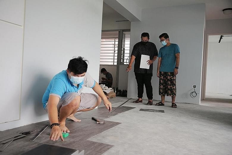 Renodiction's founder Azri Abbas having a discussion with home owner Abdul Hadi (right), in Mr Hadi's four-room Build-To-Order flat in Sengkang last Saturday. The renovation works were expected to be completed by the end of May, but this has been del