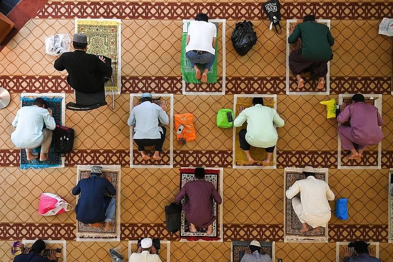 Worshippers at Masjid Maarof in Jurong West yesterday. Most mosques held three sessions with no more than 50 worshippers - who had to book slots online - each time. ST PHOTO: SHINTARO TAY