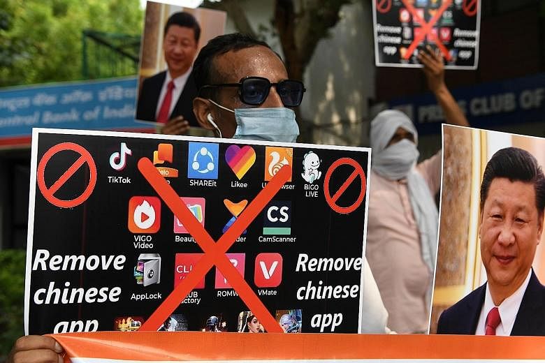 Demonstrators in New Delhi urging Indian citizens to remove Chinese apps and stop using Chinese products during an anti-China protest on June 30. PHOTO: AGENCE FRANCE-PRESSE