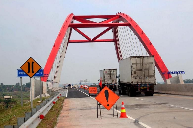 Vehicles crossing a bridge on the toll road between Batang and Semarang in Indonesia's Central Java province. A 4,300ha industrial estate in Batang is slated to open for business in the near future, tapping into demand from manufacturers diversifying
