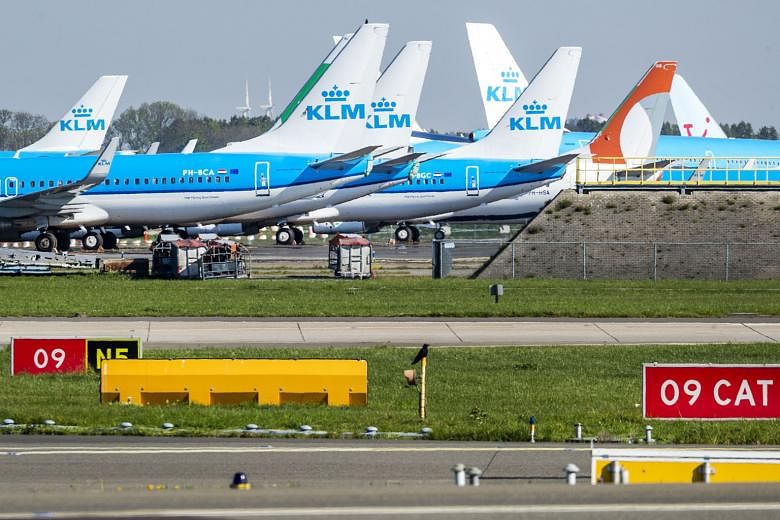 KLM planes parked on the tarmac of Schiphol airport in Amsterdam in April amid a lockdown in the Netherlands. The Dutch carrier said its planned job cuts were necessary as it had made huge losses despite a €3.4 billion (S$5.5 billion) government ba