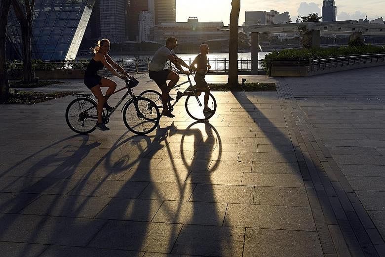 Cyclists and a jogger at the Marina Bay Waterfront Promenade in April. Exercise is more beneficial for those with a diet low in sugar and saturated fat.
