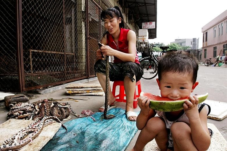 The closed Huanan Seafood Wholesale Market in Wuhan, in China's central Hubei province. The original discovery of the coronavirus in the Wuhan market sparked calls in the United States and Europe for China to close its "wet markets". A boy enjoys a s