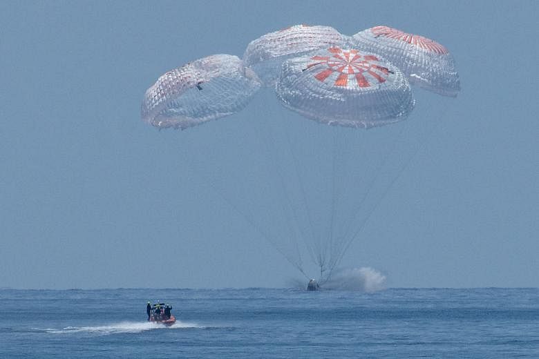 The SpaceX Crew Dragon Endeavour splashing into the waters off Pensacola, Florida, on Sunday, trailed by its four main parachutes. It was the first water landing for a crewed US spaceship since the 1975 Apollo-Soyuz mission.