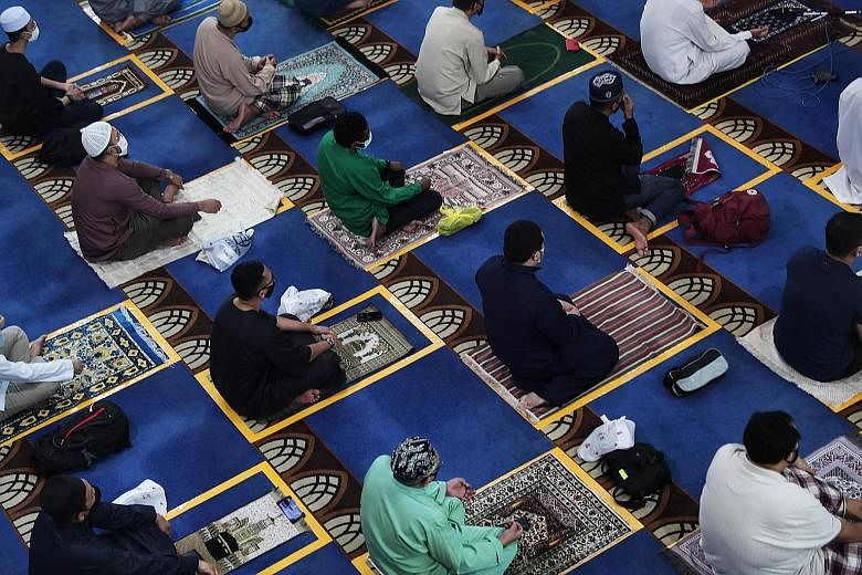 Congregants at Masjid Al-Istighfar in Pasir Ris on June 26. It is among the four mosques that will be allowed to hold gatherings of up to 100 people - double the number they are now allowed to host at any one time. They will each implement dual zones
