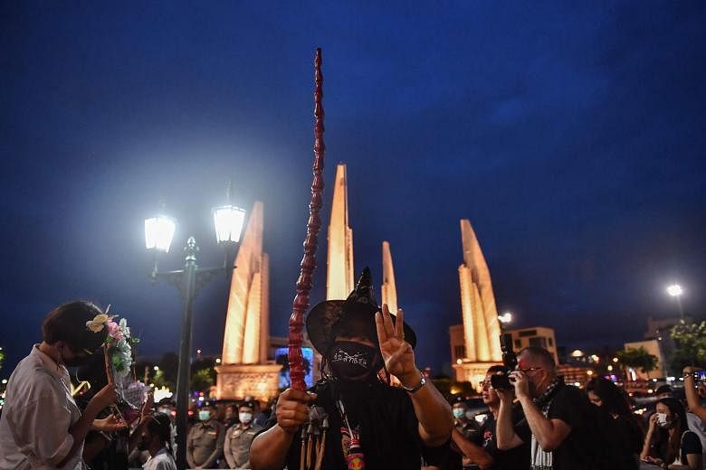 A protester flashing a three-fingered salute, portrayed in the Hunger Games books and films as a symbol of resistance, at a Harry Potter-themed rally in Bangkok on Monday. PHOTO: AGENCE FRANCE-PRESSE