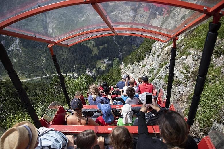 Above: Tourists taking a ride on the Gelmerbahn funicular in Bern, Switzerland. The country's public health authorities say the effectiveness of its Covid-19 tracker app is difficult to measure because of its "privacy by design". Meanwhile, Ireland's
