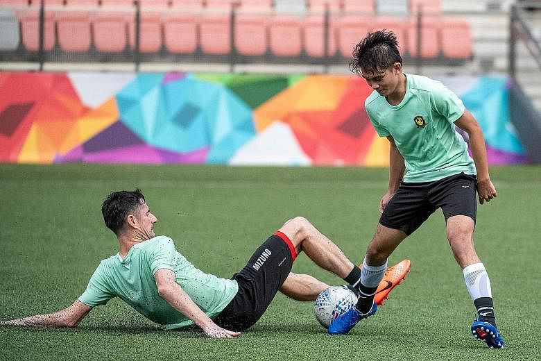Tampines Rovers' veteran defender Daniel Bennett tackling forward Danish Siregar during training at Our Tampines Hub last month. The Singapore Premier League leaders are taking gradual steps in preparing for the possible restart of play soon, with th
