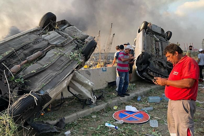 Firefighters at the scene of devastation on Tuesday. The explosions left Beirut resembling the scene of an earthquake, levelling buildings several hundred metres away. PHOTO: REUTERS Cars were flipped over and damaged by the blasts on Tuesday. Facade