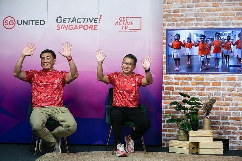 Minister for Culture, Community and Youth Edwin Tong (right) and SportSG CEO Lim Teck Yin waving to pre-schoolers yesterday.