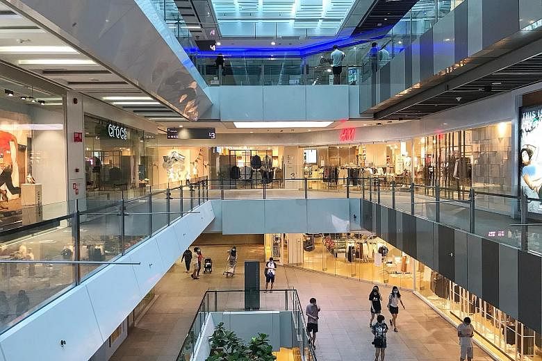 Shoppers at Jem mall in Jurong East in June after the Covid-19 circuit breaker ended. While the Singapore economy is expected to bounce back starting in the second half of this year, service sectors will likely continue suffering until a virus vaccin