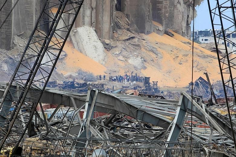 French Civil Security personnel leaving Paris on Wednesday for Beirut, with aid supplies, including medical equipment. PHOTO: REUTERS The scene of devastation (above) in Beirut's port area yesterday, during a visit by French President Emmanuel Macron
