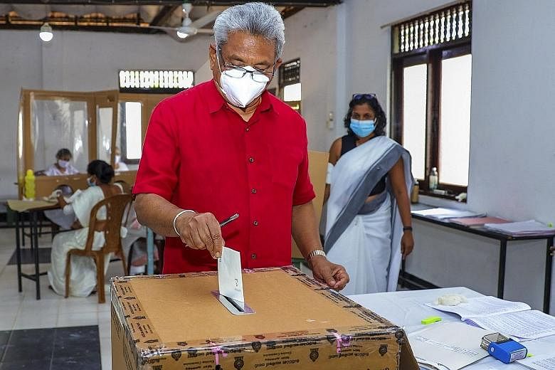 Above: Sri Lankan President Gotabaya Rajapaksa casting his ballot at a polling station in Colombo. Right: A polling official carrying ballots to a counting centre. PHOTOS: AGENCE FRANCE-PRESSE, EPA-EFE