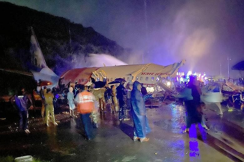 The wreckage of the Air India Express plane that split into two after it overshot the runway at the Calicut International Airport and plunged into a valley in India's southern state of Kerala last night. The Boeing 737 jet was carrying 190 people on 
