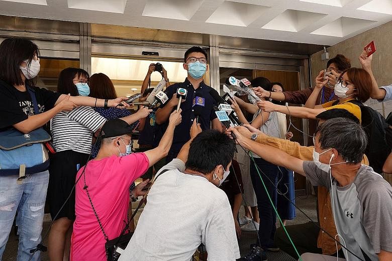 Activist Joshua Wong speaking to the media yesterday at the High Court where he lodged a judicial review over his disqualification following the 2019 district council elections. PHOTO: REUTERS