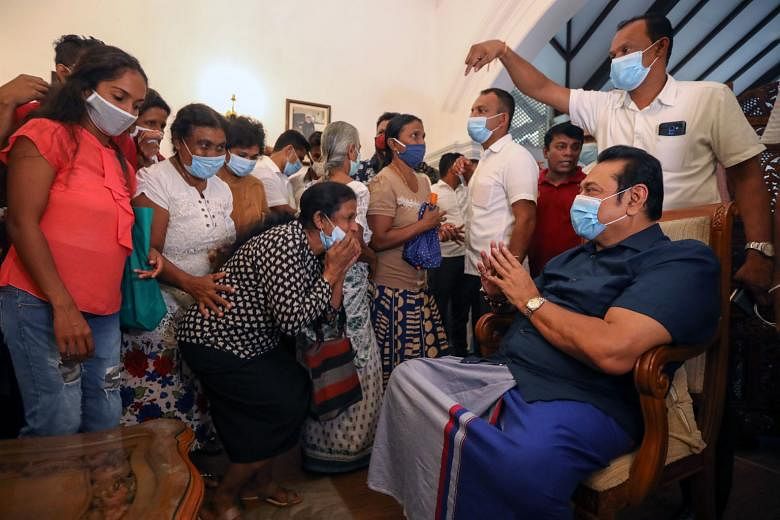 Sri Lankan Prime Minister-elect Mahinda Rajapaksa, who is the President's brother, greeting supporters at his home yesterday after the victory.