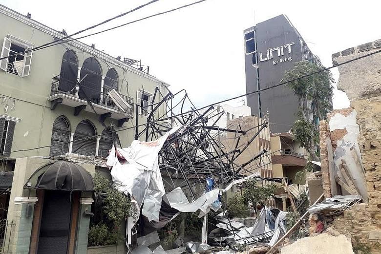 A damaged building in Mar Mikhael, a neighbourhood 2km from the Beirut blast site, on Thursday. People outside Al Roum Hospital in Beirut on Tuesday, after the explosion at the Beirut port. Even before the disaster, many Lebanese felt they were alrea