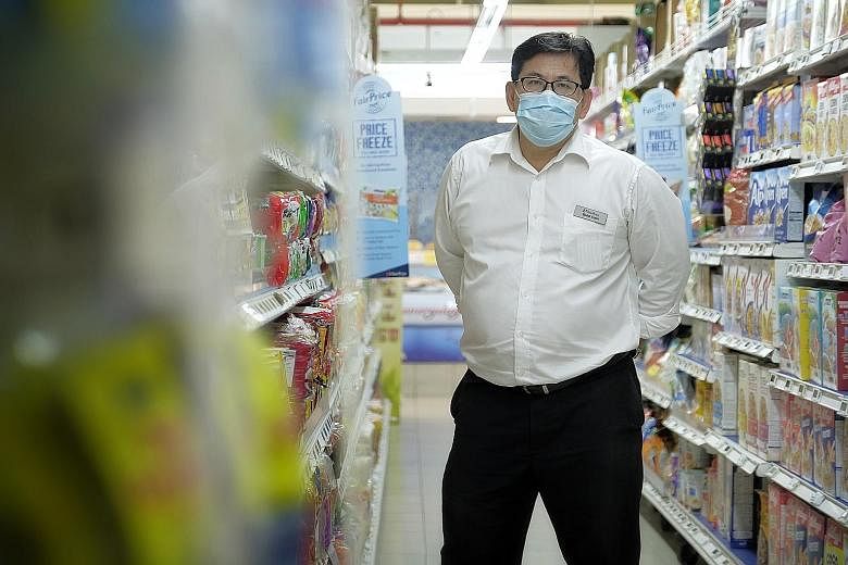 FairPrice branch manager Mohamed Amin manages a team of over 50 people at the Block 135 Jurong Gateway Road outlet. The team has put in longer hours to serve a larger volume of customers amid the pandemic.