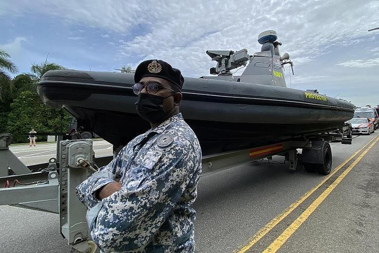 Military Expert 2 Vaengadis Waran standing in front of the Republic of Singapore Navy's Protector Unmanned Surface Vessel, which will be part of the mobile column in today's parade.