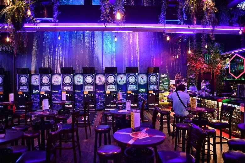 Forest Darts Cafe has reopened its Downtown East outlet but the approval process was onerous and costly, said co-owner Lena Sitoo. Few customers have returned as the darts and karaoke machines must remain powered down.