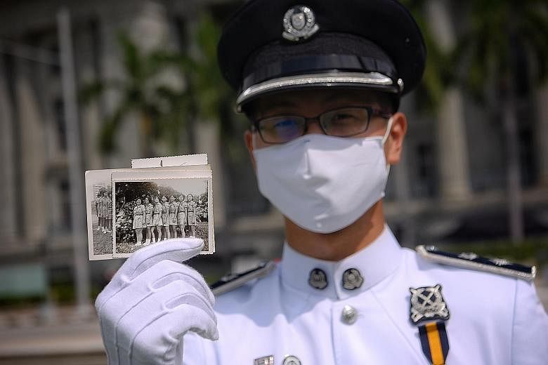 DSP Lee Ting Wei, 29, commander of the Singapore Police Force guard-of-honour contingent, with an old picture of his mother (second from right) in the Girl Guides. She took part in the 1973 National Day Parade.