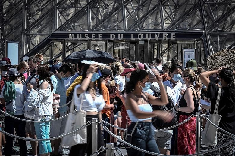 Visitors at the entrance of the Louvre museum in Paris last week. The new order, which applies to people aged 11 and over, covers busy outdoor areas in the French capital. PHOTO: AGENCE FRANCE-PRESSE