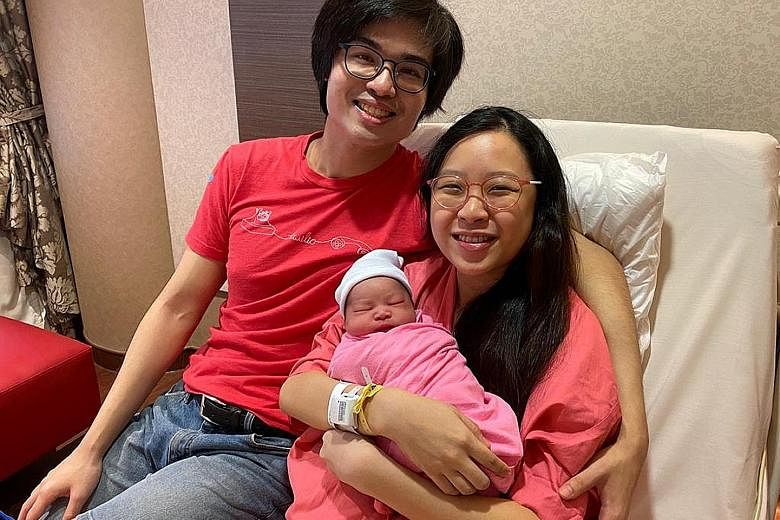Mr Jonathan Tan and his wife Natalie with their daughter Matilda, who was born at the stroke of midnight at KK Women's and Children's Hospital, making her this year's first National Day baby.