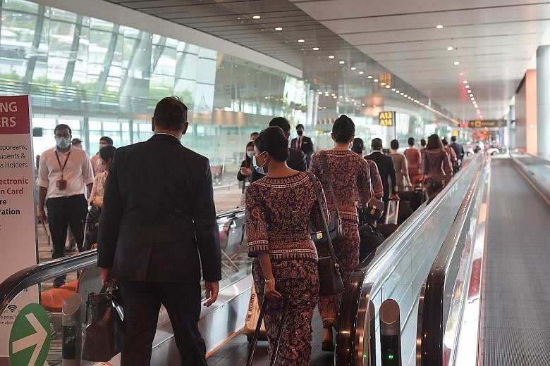 Singapore Airlines crew arriving at Changi Airport in June. The no-pay leave scheme and letting staff seek secondary employment are part of several cost-cutting measures the SIA Group has introduced as the pandemic rages on. ST PHOTO: ALPHONSUS CHERN
