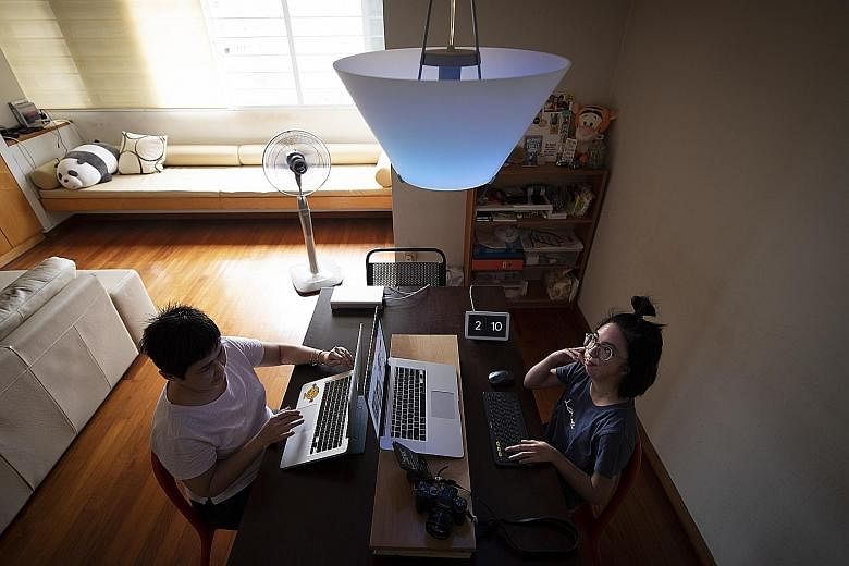 Ms Isabelle Lim (right), who is deaf, at home with her mother, Mrs Jacqueline Lim. The light above them is programmed to turn blue when it rains and to flicker when the doorbell rings. Ms Lim was involved in the development of the new Smart Home Guid