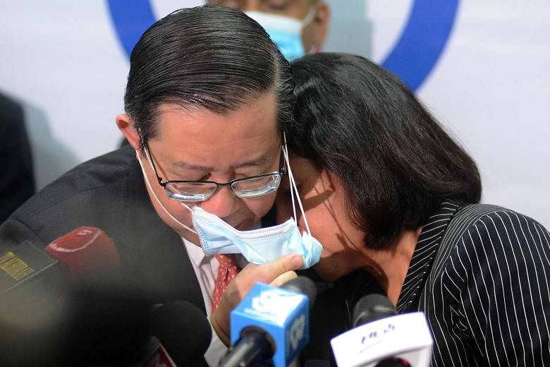 Lim Guan Eng and his wife Betty Chew after their court appearance in Penang yesterday. PHOTO: BERNAMA