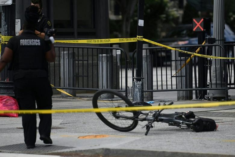 Left: A member of the Secret Service escorting US President Donald Trump out of the press room after a shooting incident outside the White House. Below: A bicycle in a cordoned-off area in Pennsylvania Avenue at the scene of the incident. The US Secr