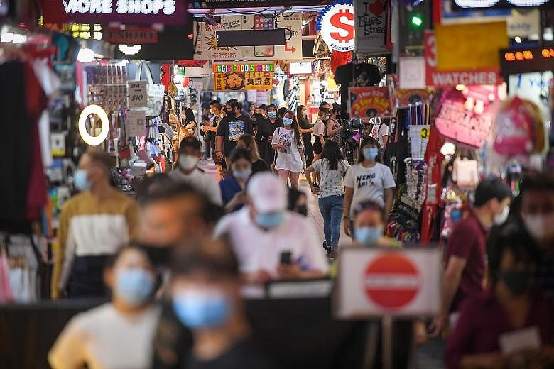 The bustle in Bugis Street on Monday, with the masks on people's faces the only giveaway that Singapore is still battling a pandemic. The currently low infection numbers here and the greater freedom to move around are a reward for everyone working to